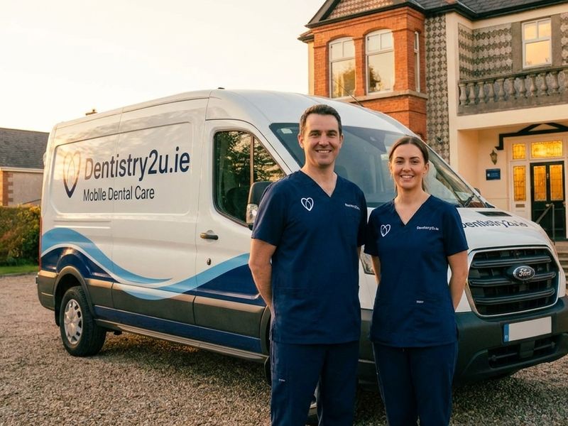 The Dentistry2U van outside a house, the dentist and nurse at the door